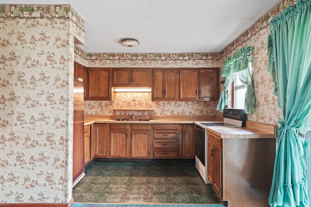 kitchen featuring white electric stove and sink