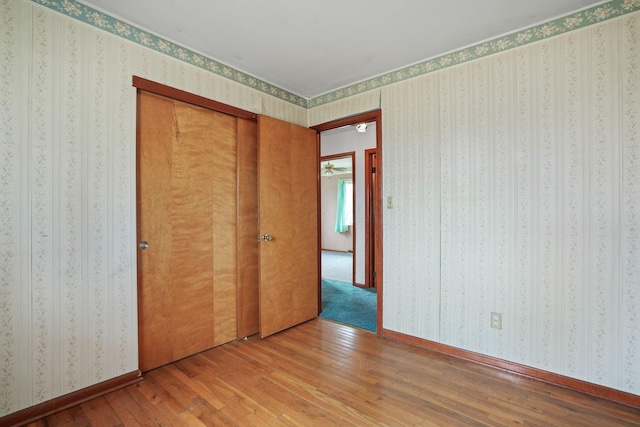 unfurnished bedroom featuring hardwood / wood-style flooring and a closet