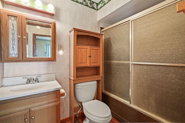 full bathroom featuring bath / shower combo with glass door, vanity, and toilet