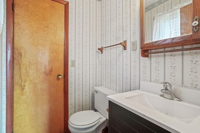 bathroom featuring vanity and toilet