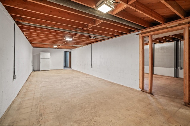 basement featuring white fridge