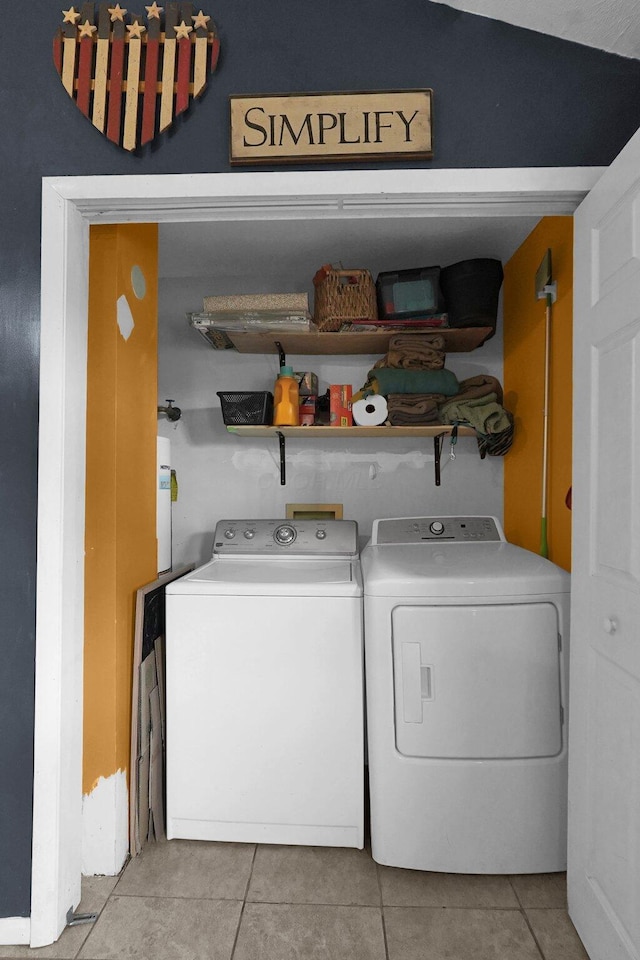 laundry room with light tile patterned floors and independent washer and dryer