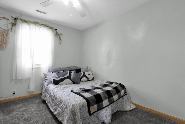 bedroom with dark carpet and ceiling fan