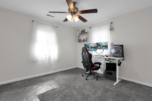 office space featuring ceiling fan and dark colored carpet