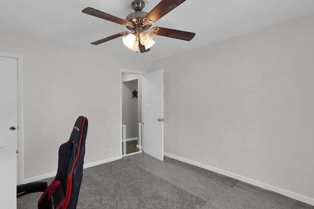 unfurnished office with ceiling fan and dark carpet