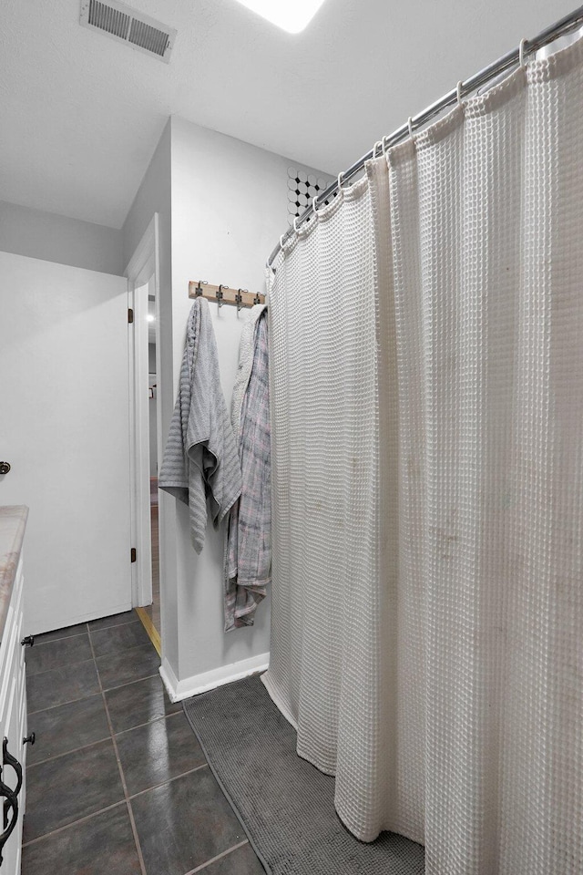 bathroom featuring tile patterned flooring, vanity, and a shower with shower curtain