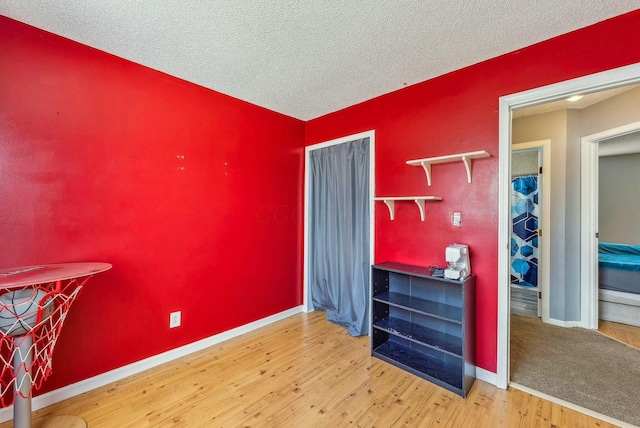 misc room with hardwood / wood-style flooring and a textured ceiling