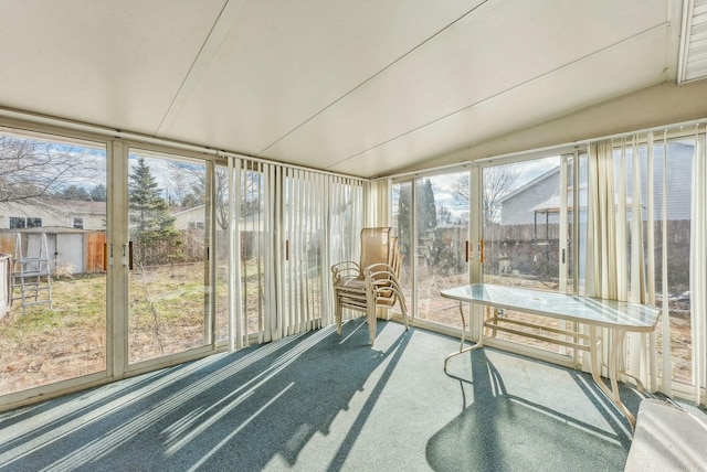 unfurnished sunroom featuring lofted ceiling