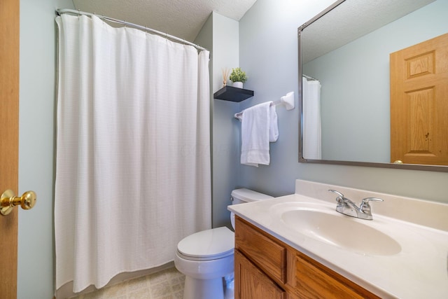 bathroom featuring vanity, toilet, and a textured ceiling