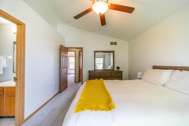 bedroom featuring lofted ceiling, sink, light colored carpet, ceiling fan, and ensuite bath