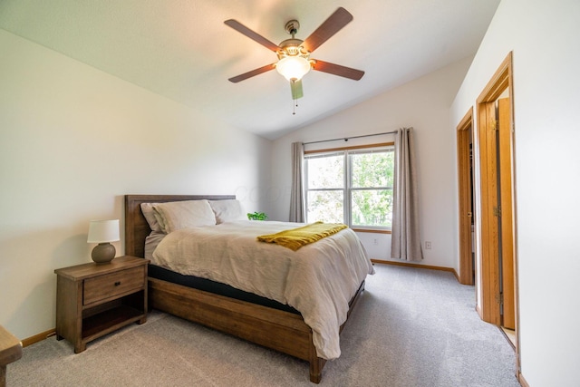 carpeted bedroom with ceiling fan and lofted ceiling