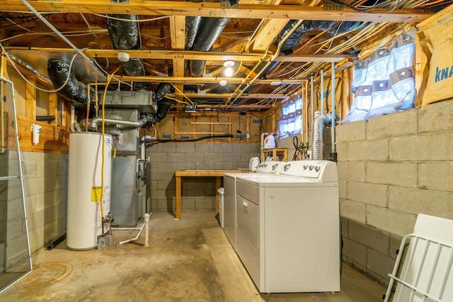 basement featuring heating unit, separate washer and dryer, and water heater