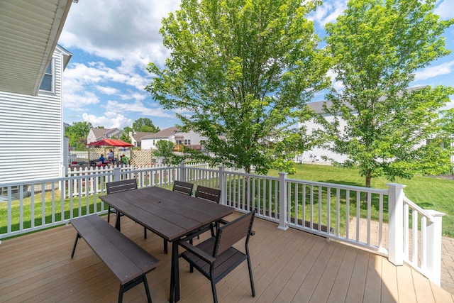 wooden terrace featuring a lawn