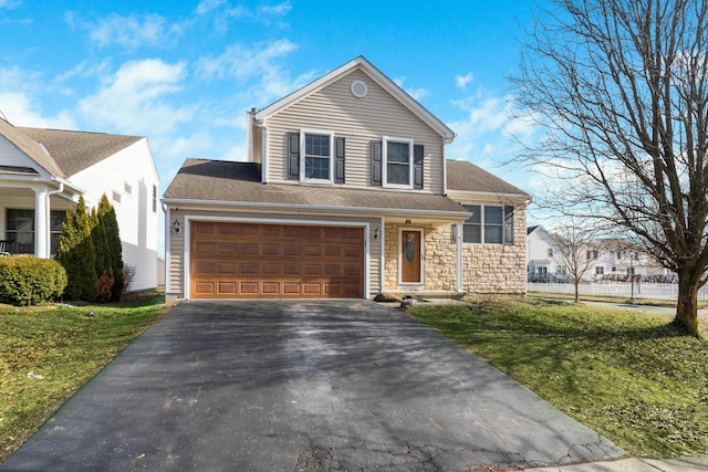 view of front of house with a garage and a front lawn