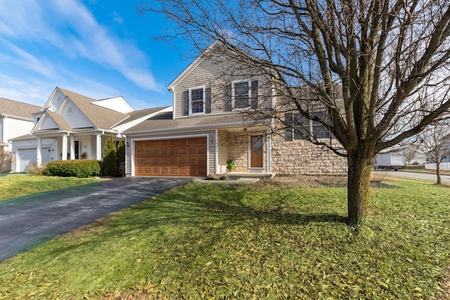 view of property with a garage and a front yard