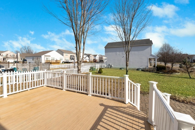 wooden deck featuring a lawn