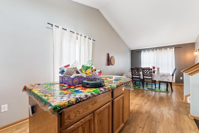 game room with vaulted ceiling and light wood-type flooring