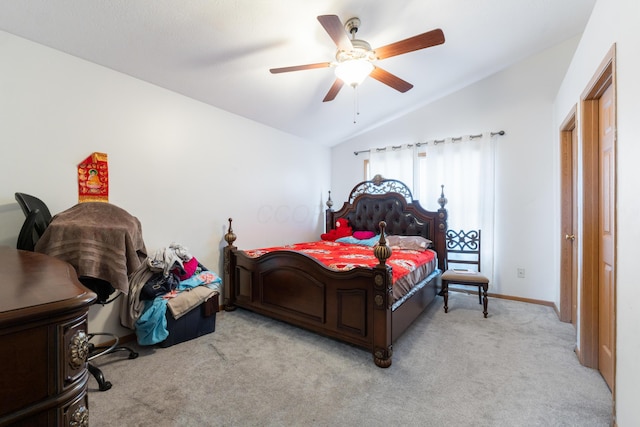 bedroom with vaulted ceiling, light colored carpet, and ceiling fan