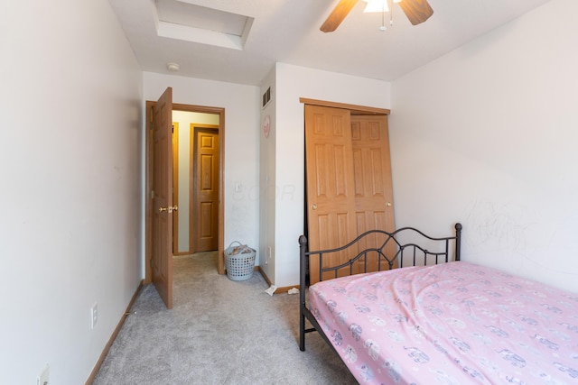 carpeted bedroom featuring a closet and ceiling fan