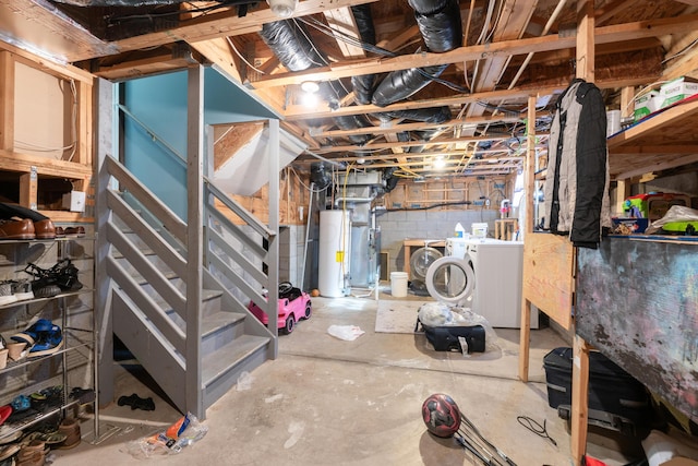 basement featuring gas water heater and washing machine and dryer