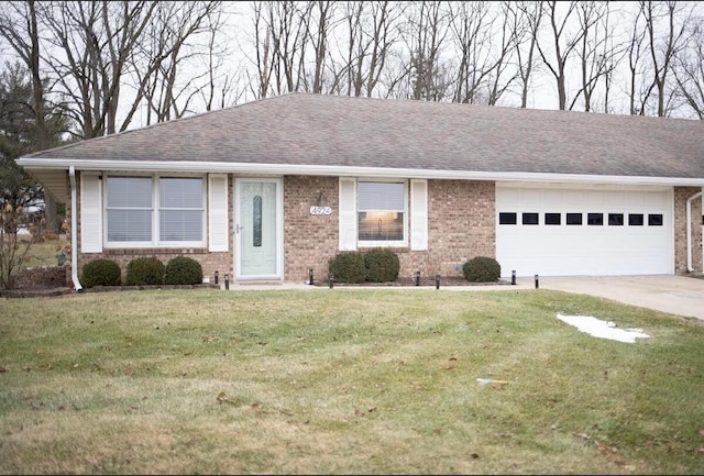 ranch-style home featuring a garage and a front yard