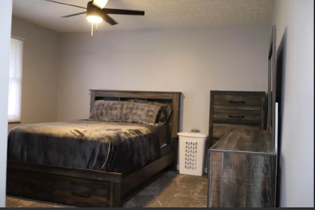 bedroom featuring ceiling fan and dark colored carpet