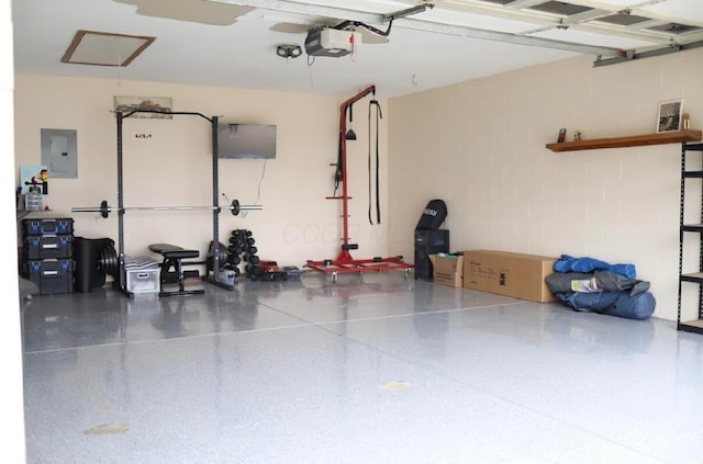 garage with a garage door opener and electric panel