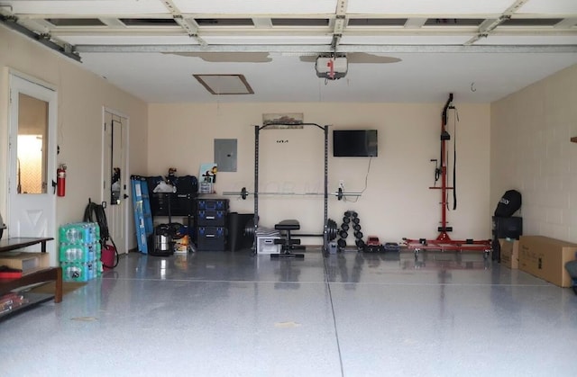 garage with a garage door opener and electric panel