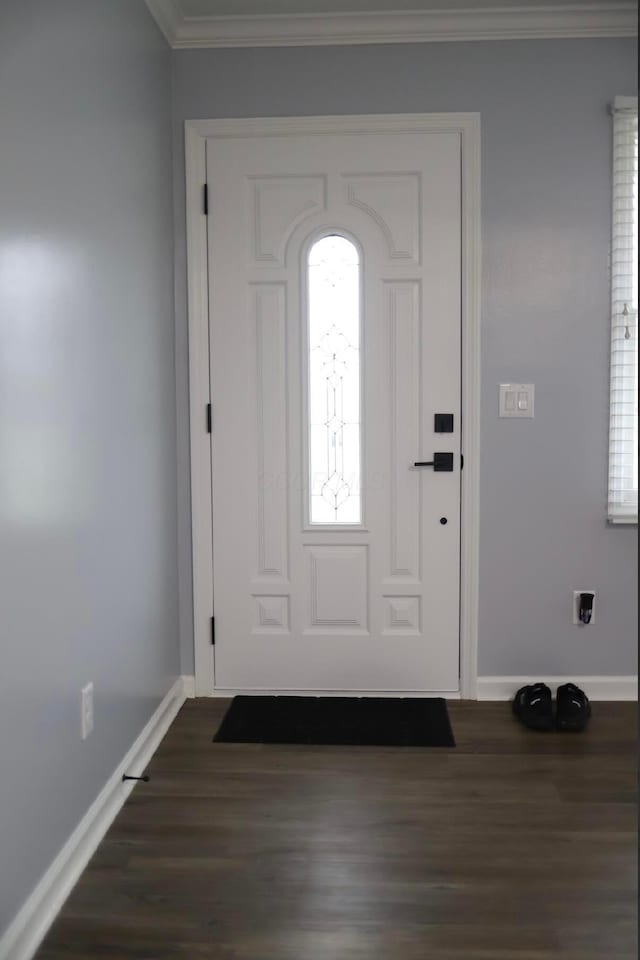 foyer entrance with crown molding and dark hardwood / wood-style floors