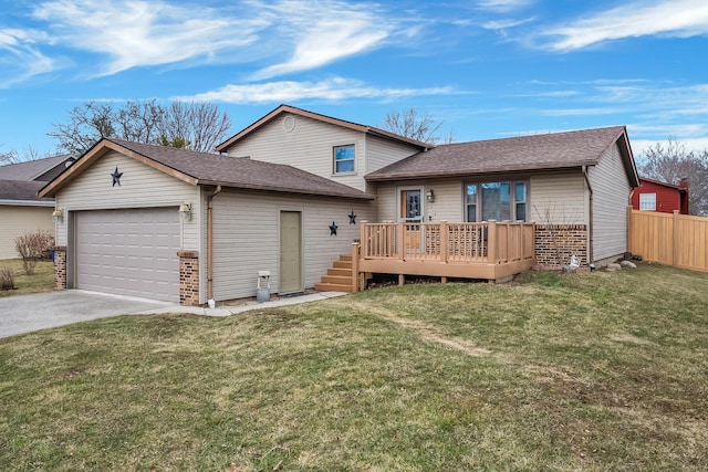 split level home featuring an attached garage, fence, a front lawn, and concrete driveway