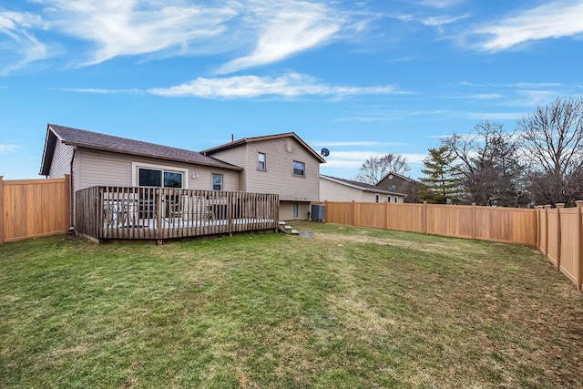 rear view of house featuring a yard, a fenced backyard, and a wooden deck