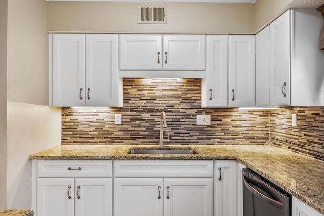 kitchen featuring dishwasher, visible vents, white cabinets, and a sink