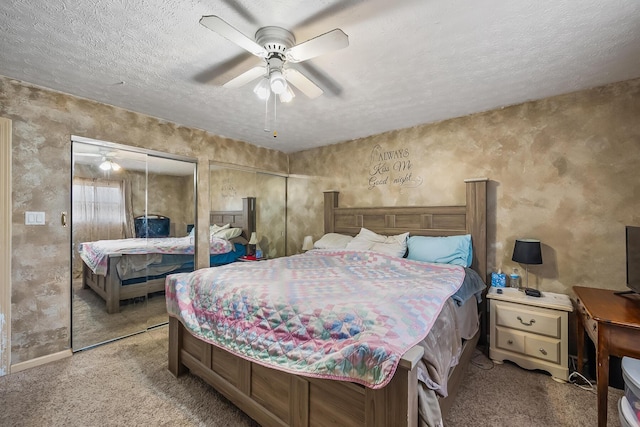 carpeted bedroom with a ceiling fan and a textured ceiling