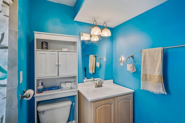 bathroom featuring toilet and vanity