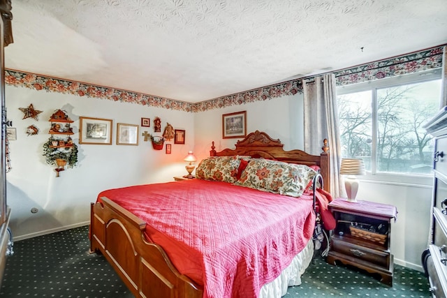 bedroom with a textured ceiling and dark colored carpet