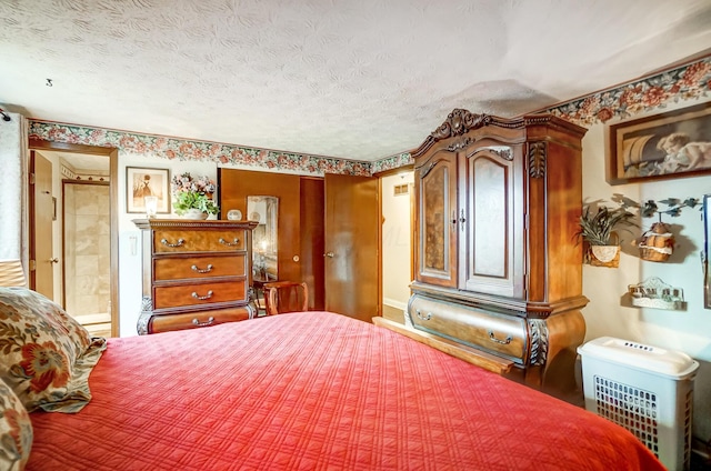 bedroom with connected bathroom and a textured ceiling