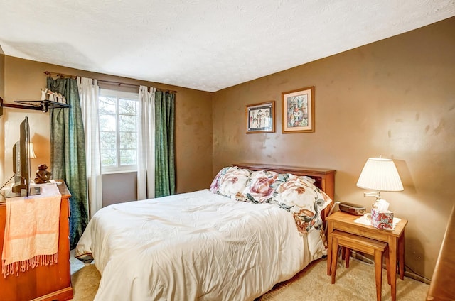 carpeted bedroom featuring a textured ceiling