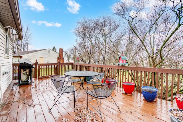 wooden deck featuring a grill