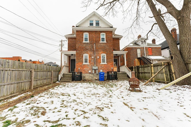 snow covered property with cooling unit