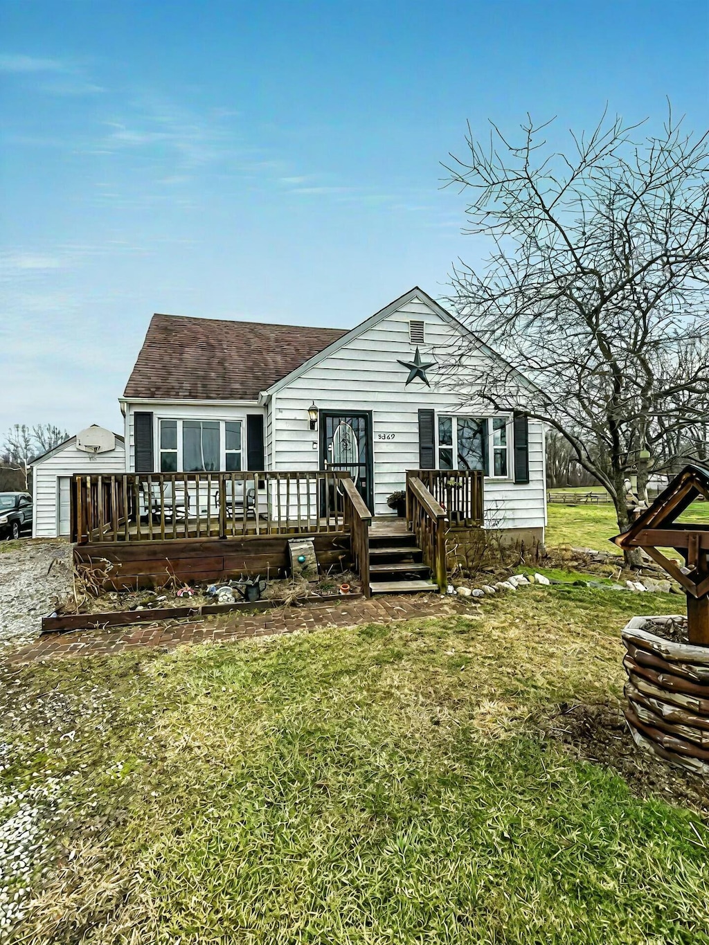 rear view of house featuring a lawn