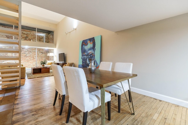 dining space with hardwood / wood-style flooring