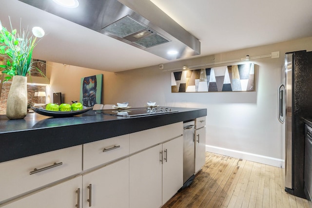 kitchen with wall chimney range hood, white cabinetry, hardwood / wood-style floors, black electric cooktop, and stainless steel fridge with ice dispenser