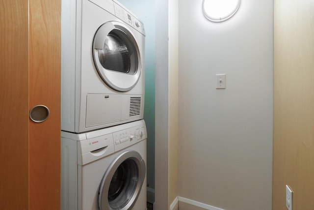 laundry room with stacked washer / drying machine