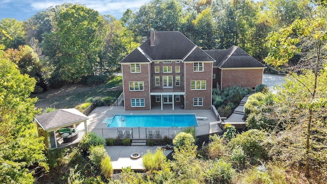 back of property with a gazebo and a patio area