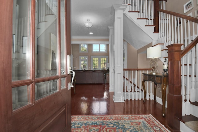 foyer entrance featuring ornamental molding and dark hardwood / wood-style floors