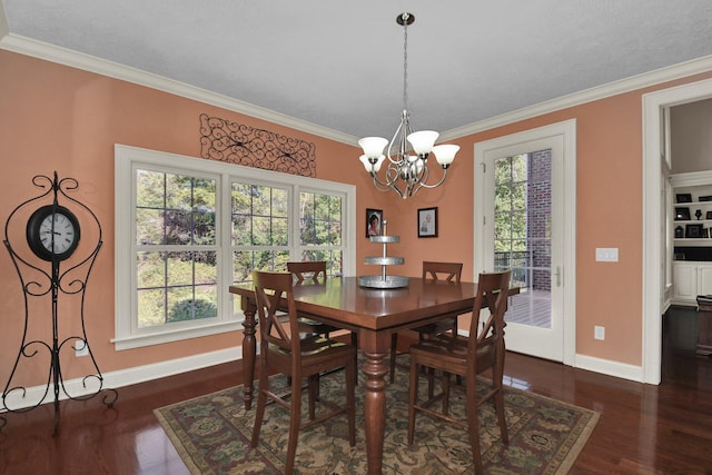 dining room with ornamental molding, dark hardwood / wood-style floors, a chandelier, and plenty of natural light