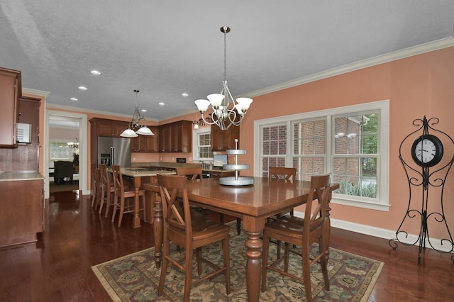 dining room with a notable chandelier, crown molding, dark wood-type flooring, and a textured ceiling