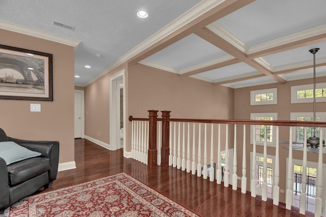 hallway featuring coffered ceiling, dark hardwood / wood-style flooring, ornamental molding, and beamed ceiling