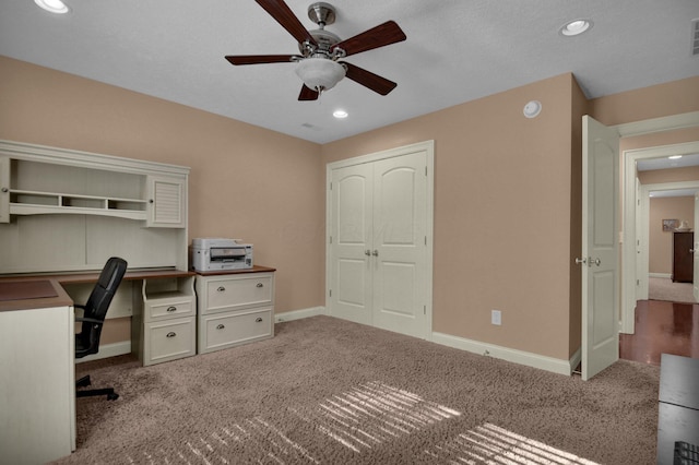 office space featuring light carpet and ceiling fan