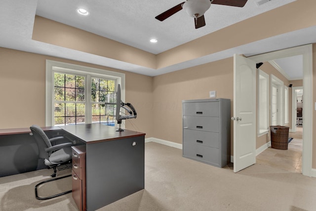 carpeted office space with ceiling fan and a textured ceiling